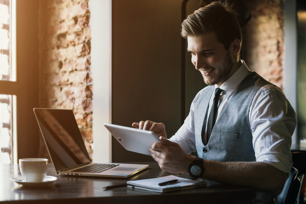 Businessman looking at his tablet