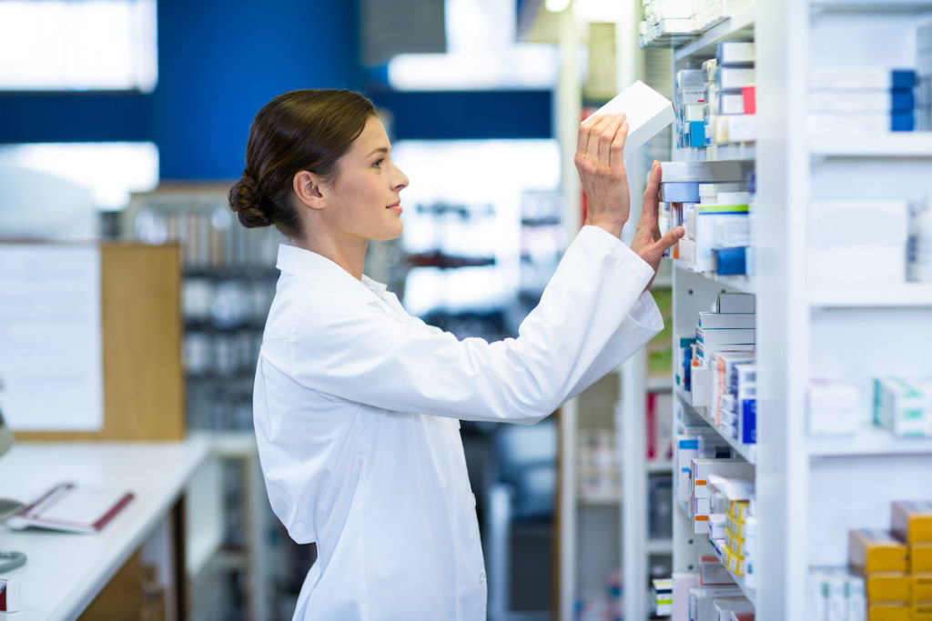 pharmacist pulling something out of the shelf