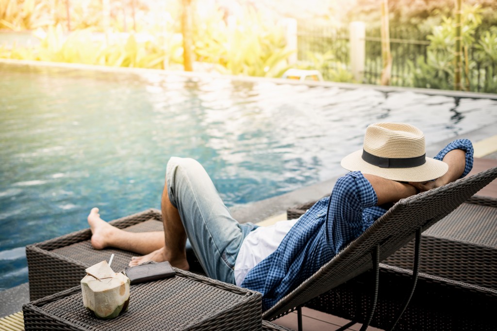 man chilling beside the pool