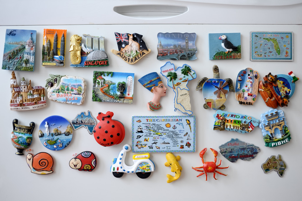 many different travel magnet souvenires