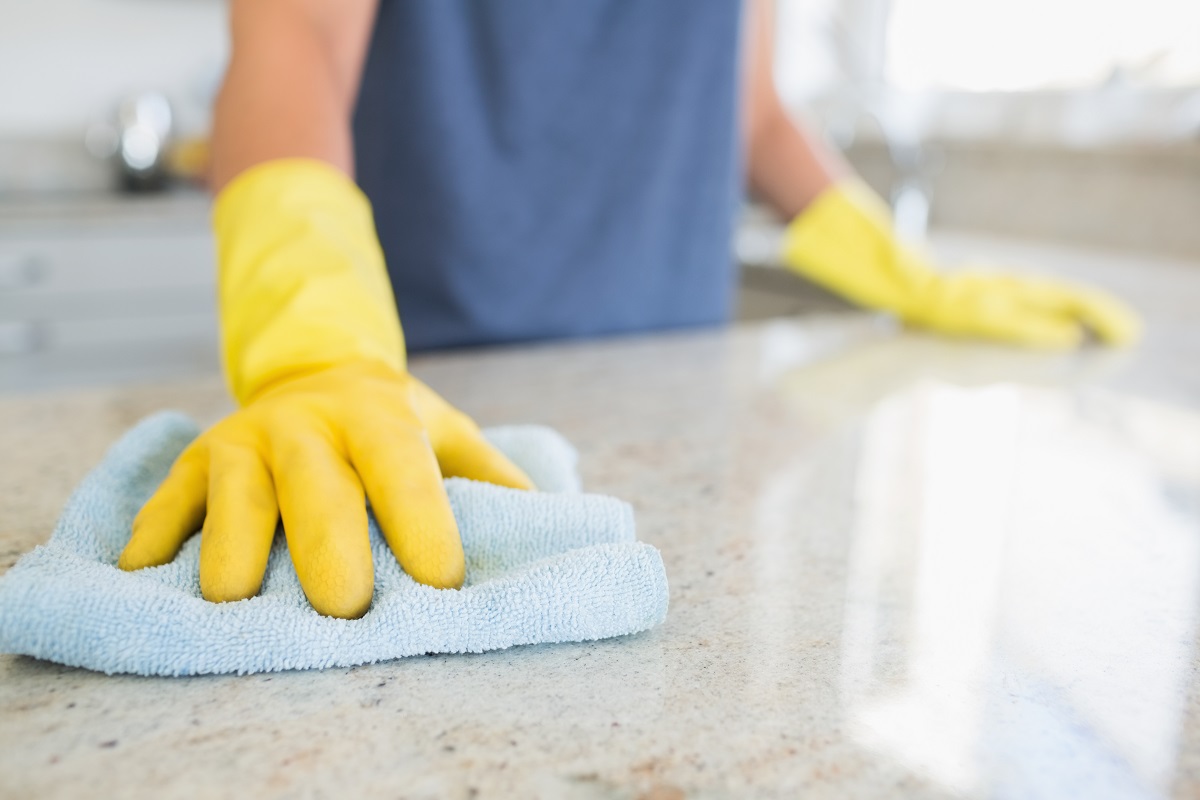 wiping kitchen countertop