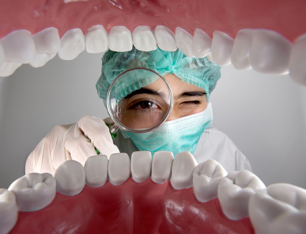 Dentist checking teeth of a patient