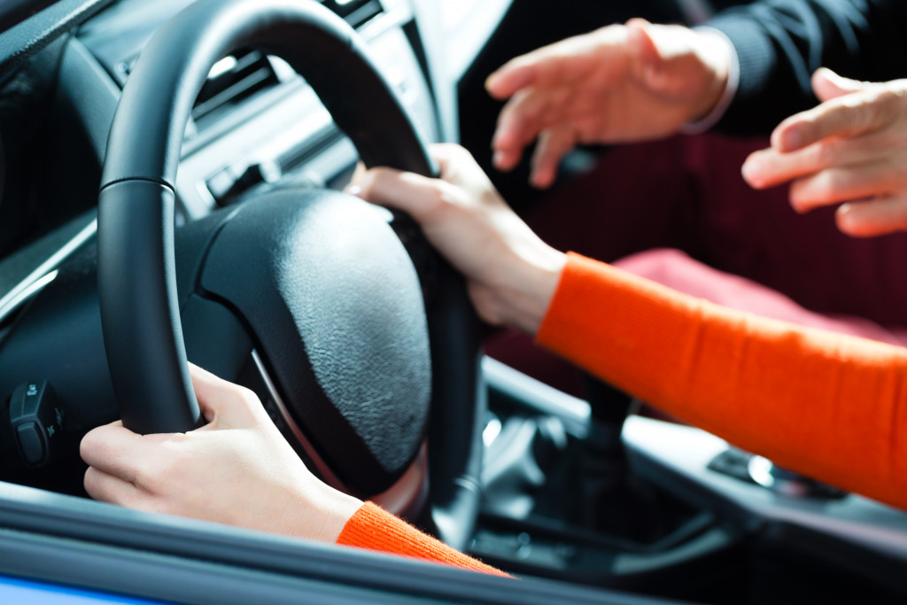 A teenager being taught how to drive