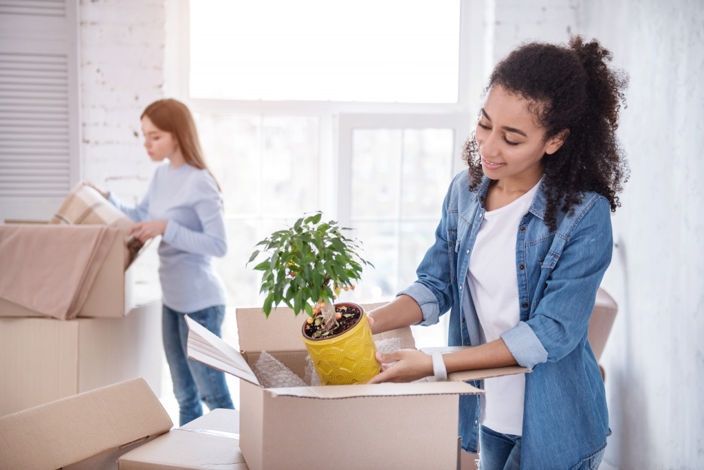 two female college students unpacking their things