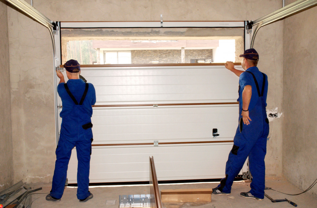 man installing garage door