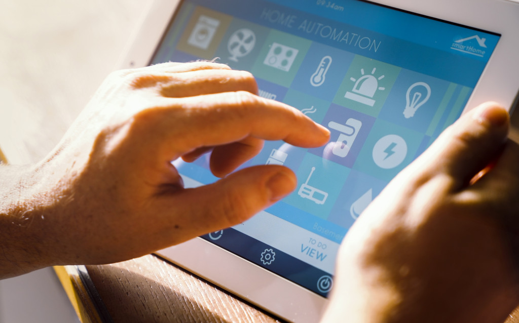 a man holding a tablet device to check smart home