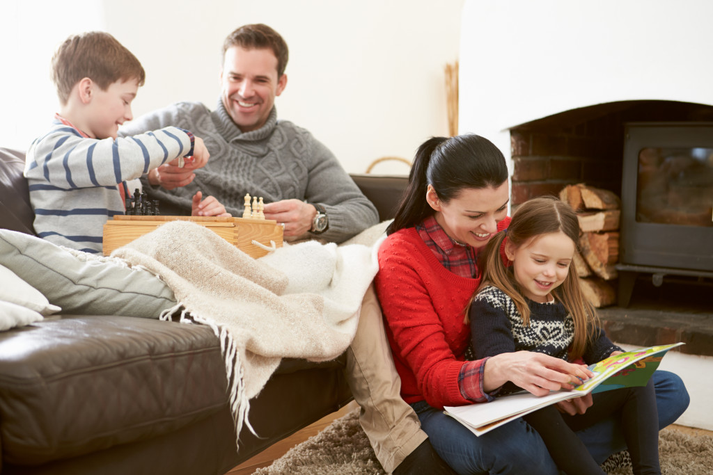 happy family sitting by the fireplace