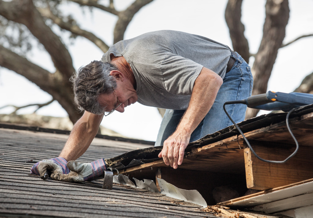 a man upgrading the roofing with power tools