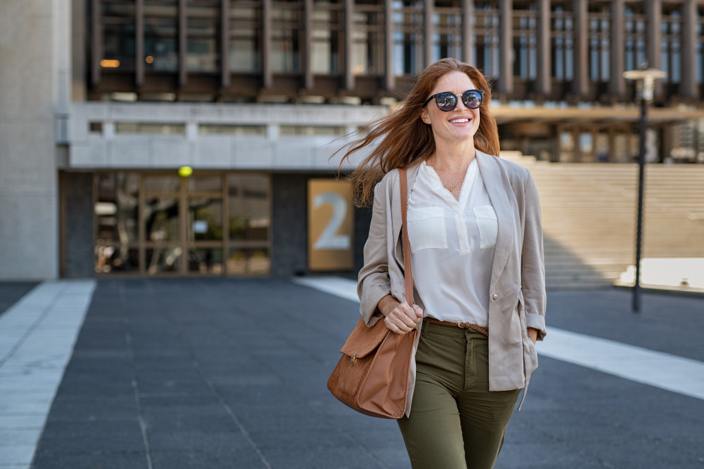 a woman on a summer fashion carrying a bag