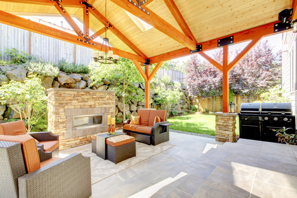 A beautiful covered patio with furniture and fireplace