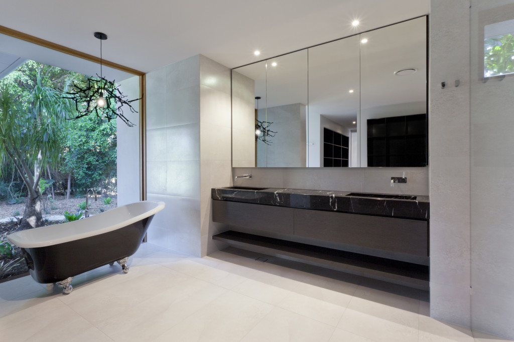 A luxurious bathroom with a bathtub and mirror sink