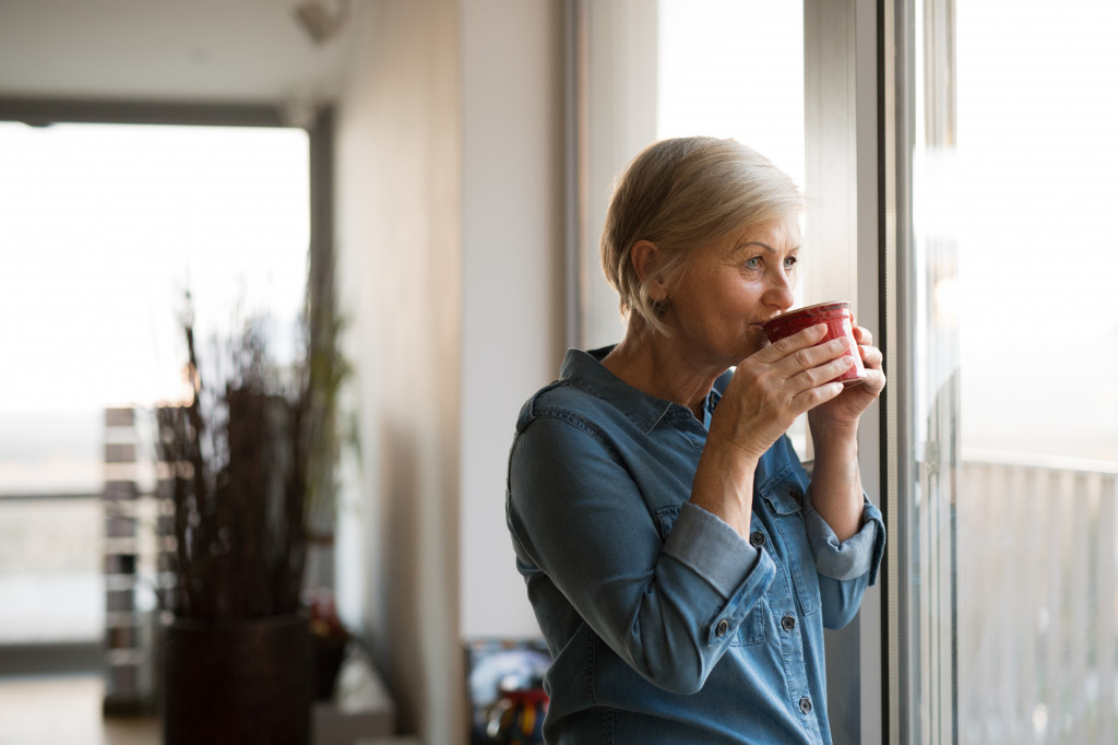 senior woman alone at home drinking coffee